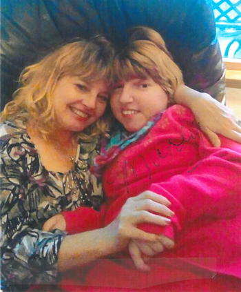 A photo of Mandy and her mom curled up in a recliner