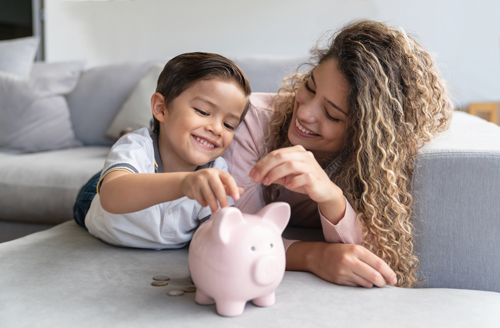 a photo of a mom and son putting coins in a piggy bank
